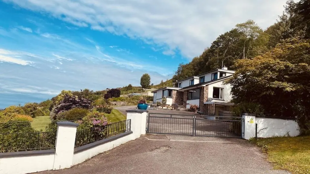 a house on a hill with a fence at Foinaven House in Ullapool