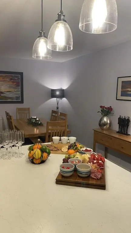 a kitchen with a table with a tray of food at Foinaven House in Ullapool