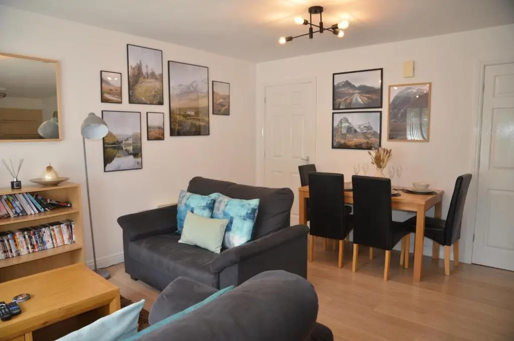 a living room with a couch and a table at SCOTTISH HIGHLANDS Superb 2 bedroom apartment. in Invergarry