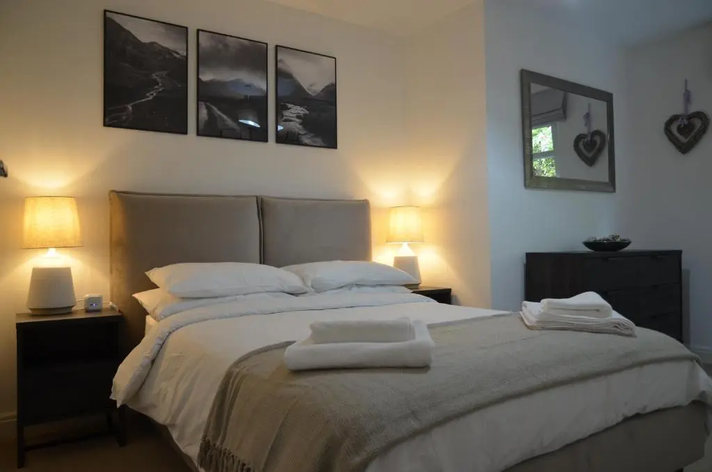 a bedroom with a large bed with towels on it at SCOTTISH HIGHLANDS Superb 2 bedroom apartment. in Invergarry