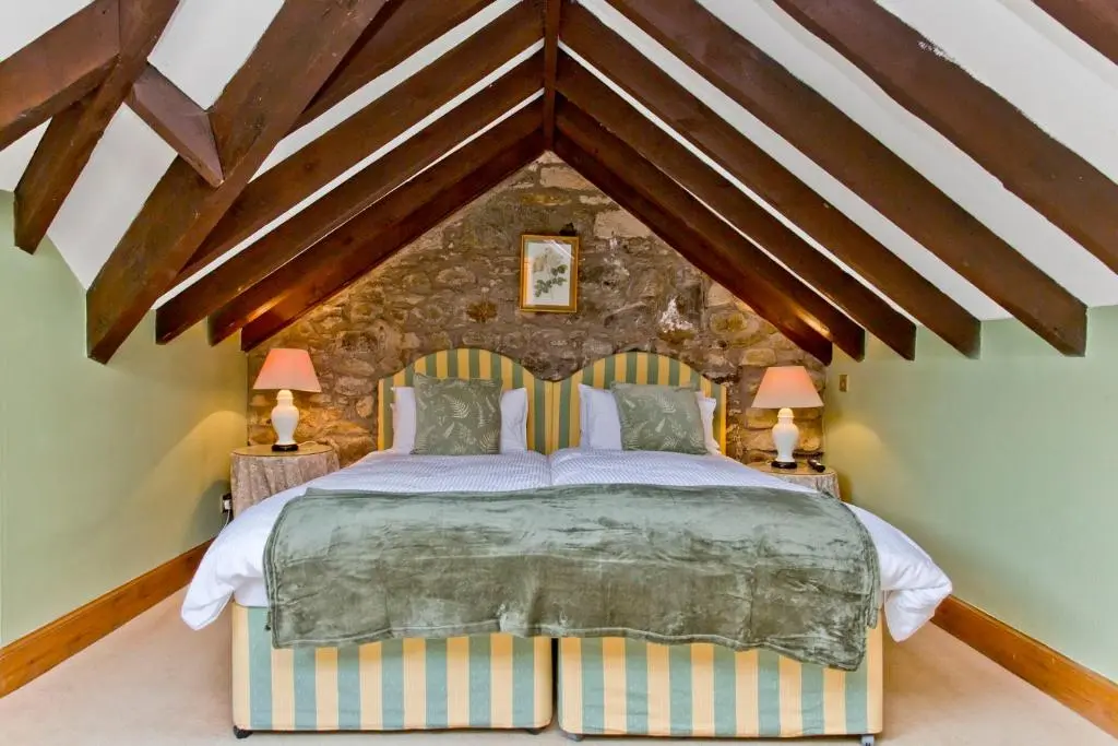 a bedroom with a large bed in a room at Dalnaglar Castle in Blairgowrie