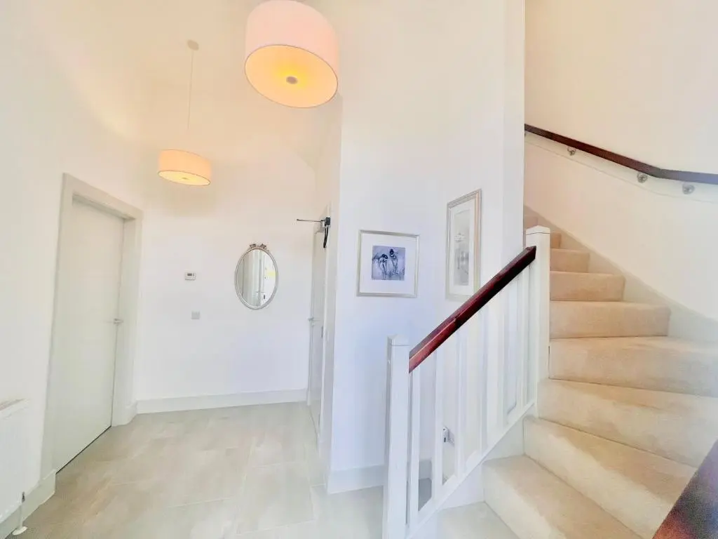 a staircase in a home with white walls and white floors at Great Glen Townhouse Inverness - Entire 3 Story Townhouse in Inverness