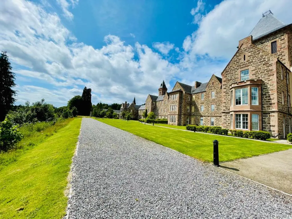 an estate with a large building with a green lawn at Great Glen Townhouse Inverness - Entire 3 Story Townhouse in Inverness