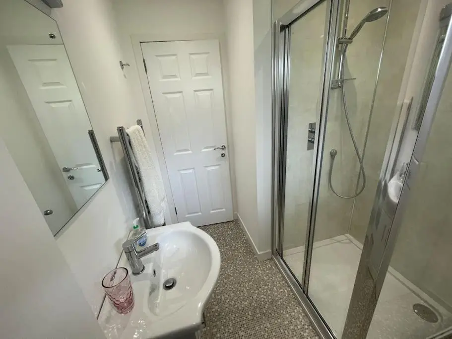 a bathroom with a sink and a shower at 'Edgewood' - spacious detached bungalow in Inverness