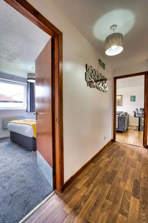 a room with a bed and a door to a room at Two Bed Holiday Home with Free Parking in Inverness in Inverness