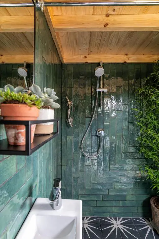 a shower in a bathroom with green tiles at Alba - Charming boutique forest view cabin with hot tub in Ballater in Ballater