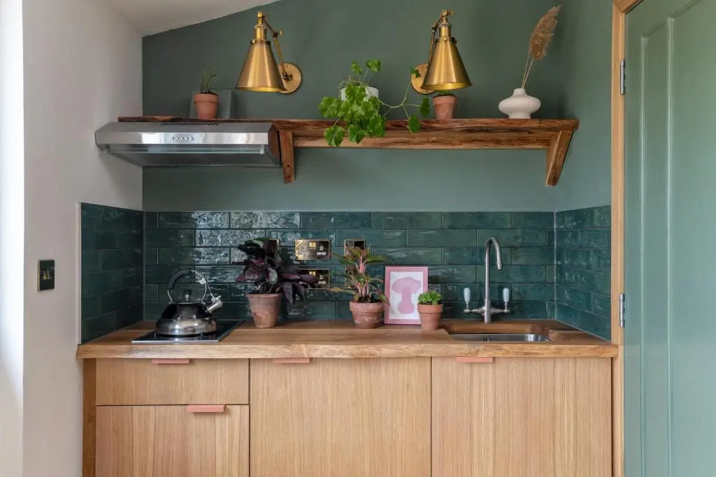 a kitchen with green tiled walls and a sink at Alba - Charming boutique forest view cabin with hot tub in Ballater in Ballater