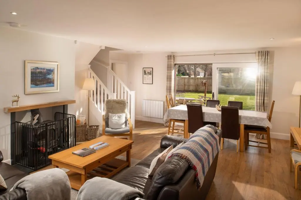 a living room with a couch and a table at Anne's Place in Boat of Garten