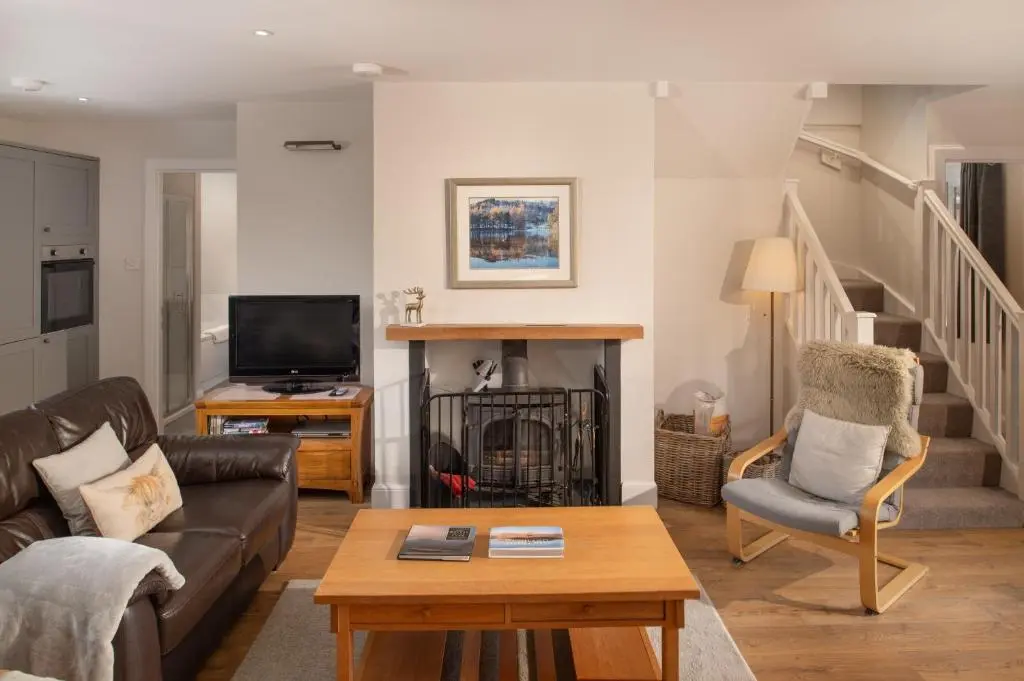 a living room with a couch and a tv at Anne's Place in Boat of Garten