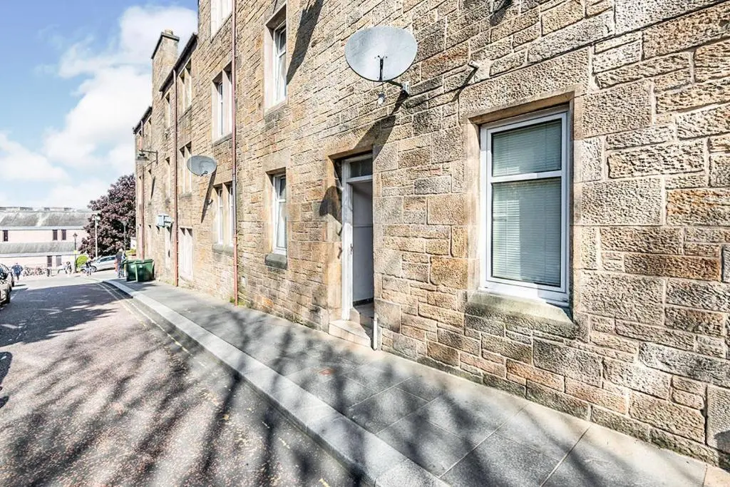 a brick building with a window on the side of it at Stephen's Street Apartment, Inverness City Centre in Inverness