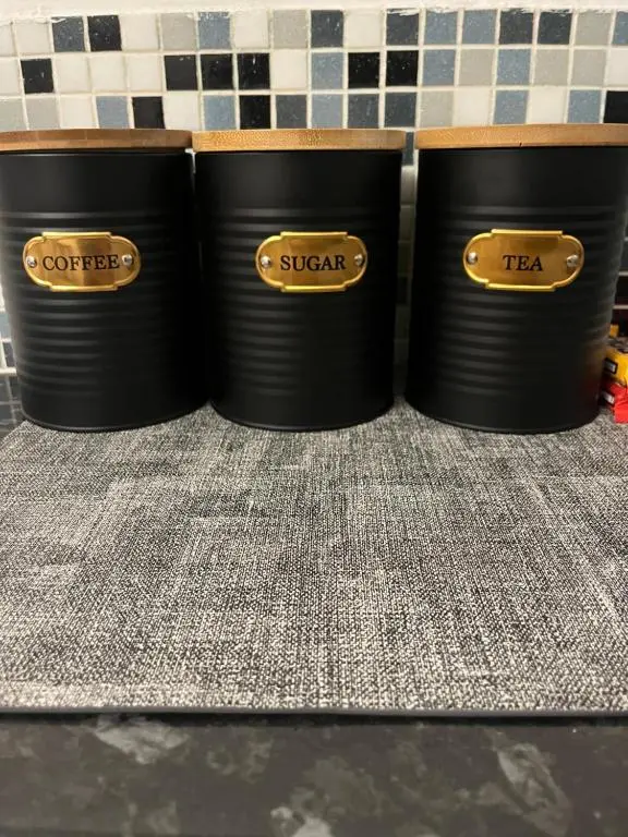 three black trash cans sitting on a shelf at Stephen's Street Apartment, Inverness City Centre in Inverness