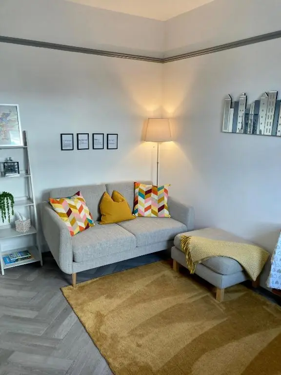 a living room with a couch and a table at Haugh Ness in Inverness