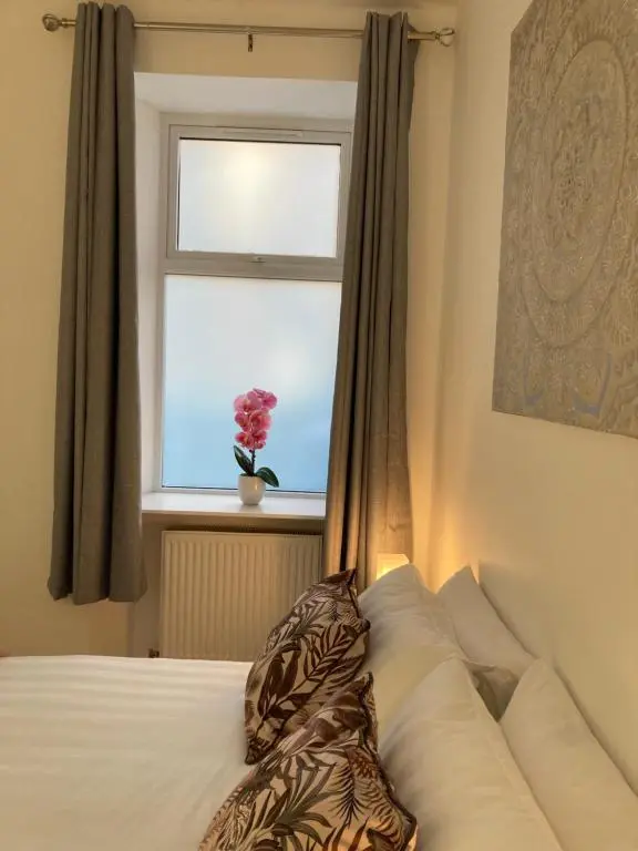 a bed with a pillow in front of a window at Haugh Ness in Inverness