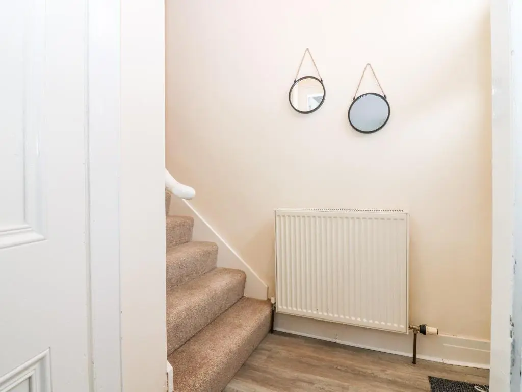 a hallway with stairs and a radiator at RockStar Cottage in Macduff