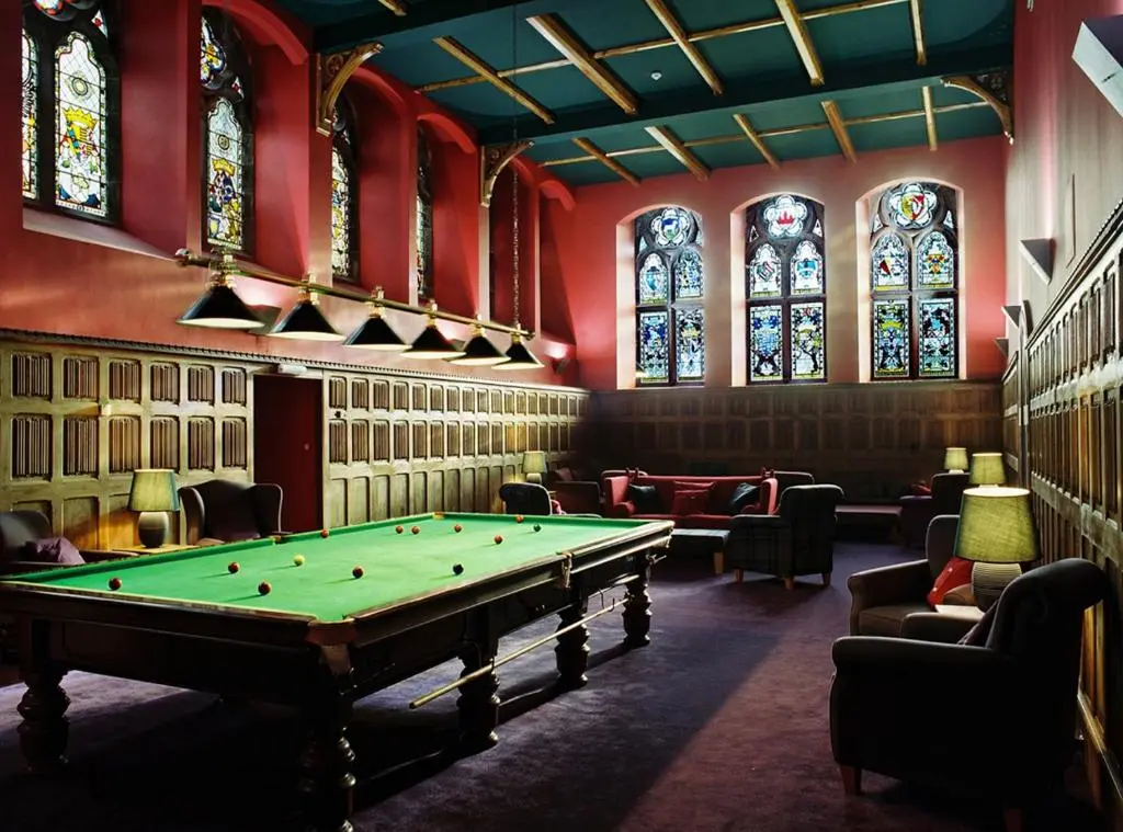 a room with a pool table and stained glass windows at Raven Wing Apartments - Highland Club Scotland in Fort Augustus