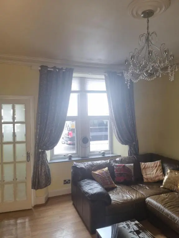 a living room with a couch and a window at Nanny Bambi's highland hoose in Inverness
