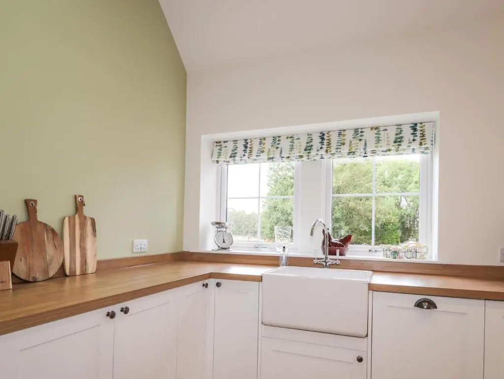 a kitchen with a sink and a window at Bonnach in Muir of Ord