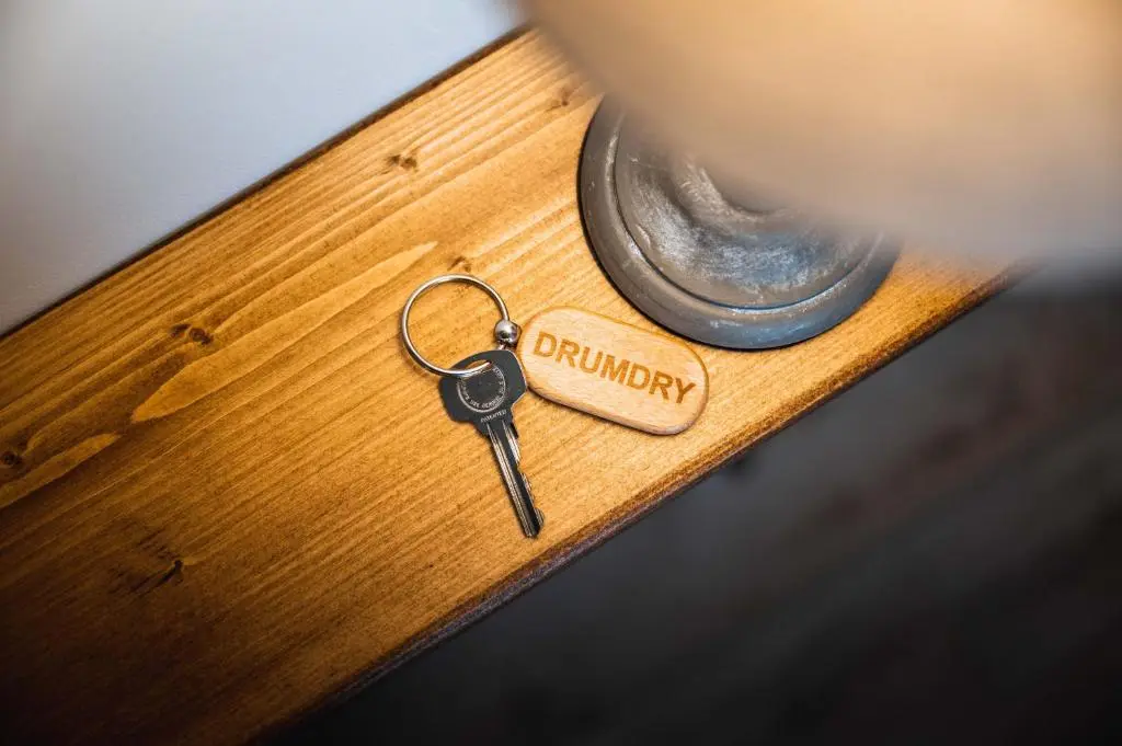 a pair of keys sitting on top of a wooden table at Drumdry in Wick