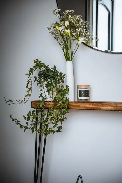 a shelf with a vase of flowers on it at Drumdry in Wick