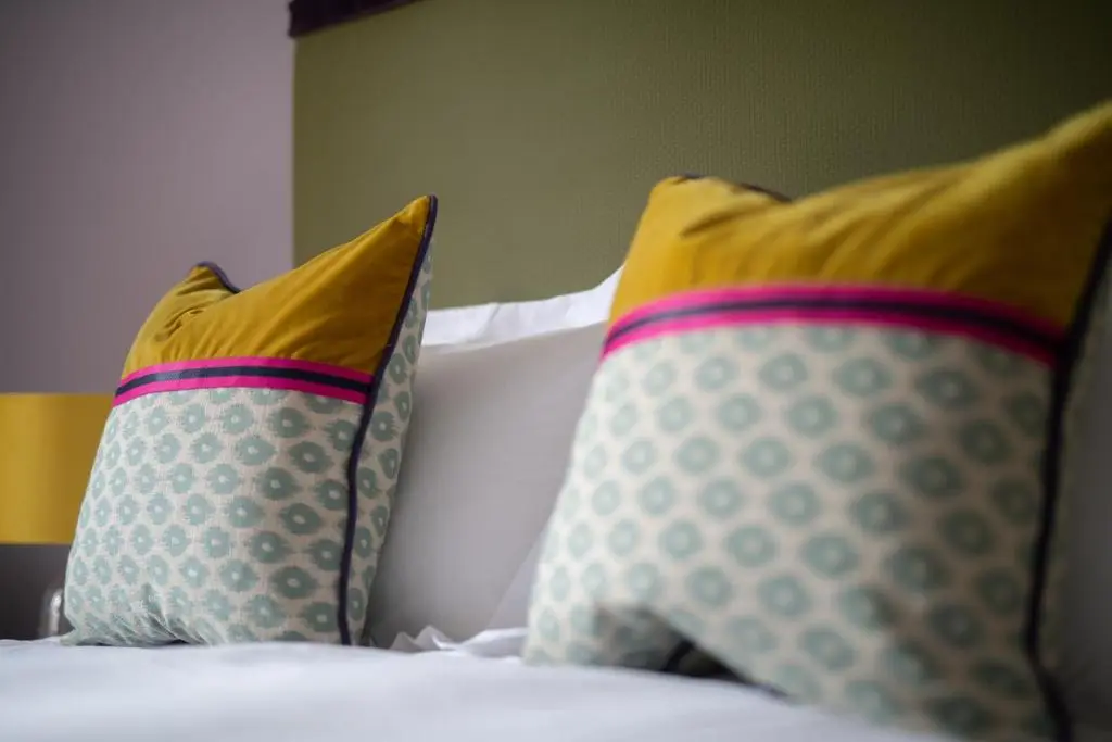 a bed with two pillows on top of it at Lock Keepers Cottage, Loch Ness Cottage Collection in Inverness