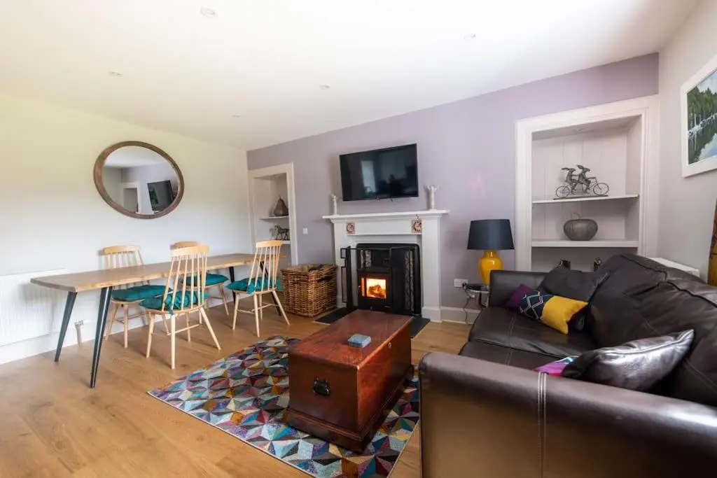 a living room with a couch and a table at Lock Keepers Cottage, Loch Ness Cottage Collection in Inverness