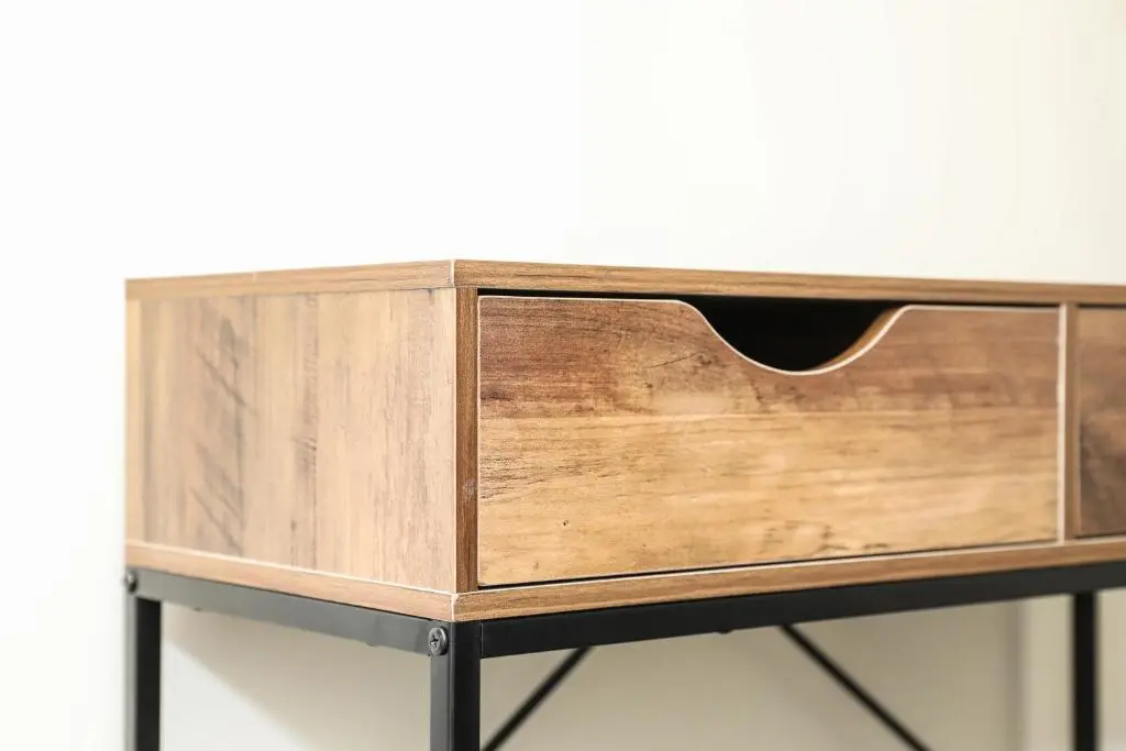 a wooden cabinet on a metal stand on a table at mySTAYINN Tomnahurich Guest House in Inverness