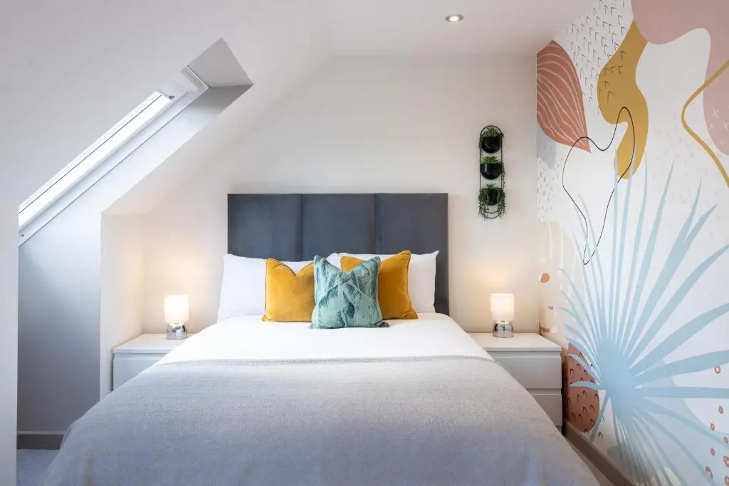 a bedroom with a large bed with two lamps at Fern View in Inverness