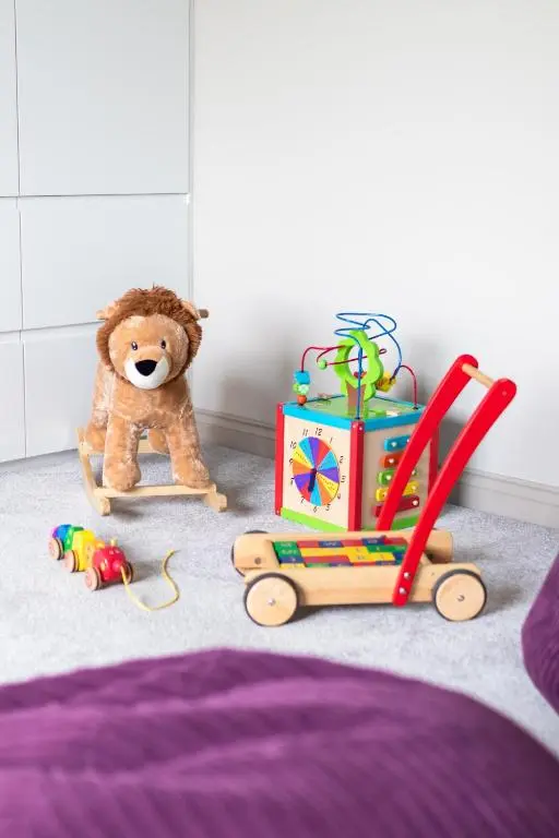 a teddy bear and toys in a bedroom at Fern View in Inverness