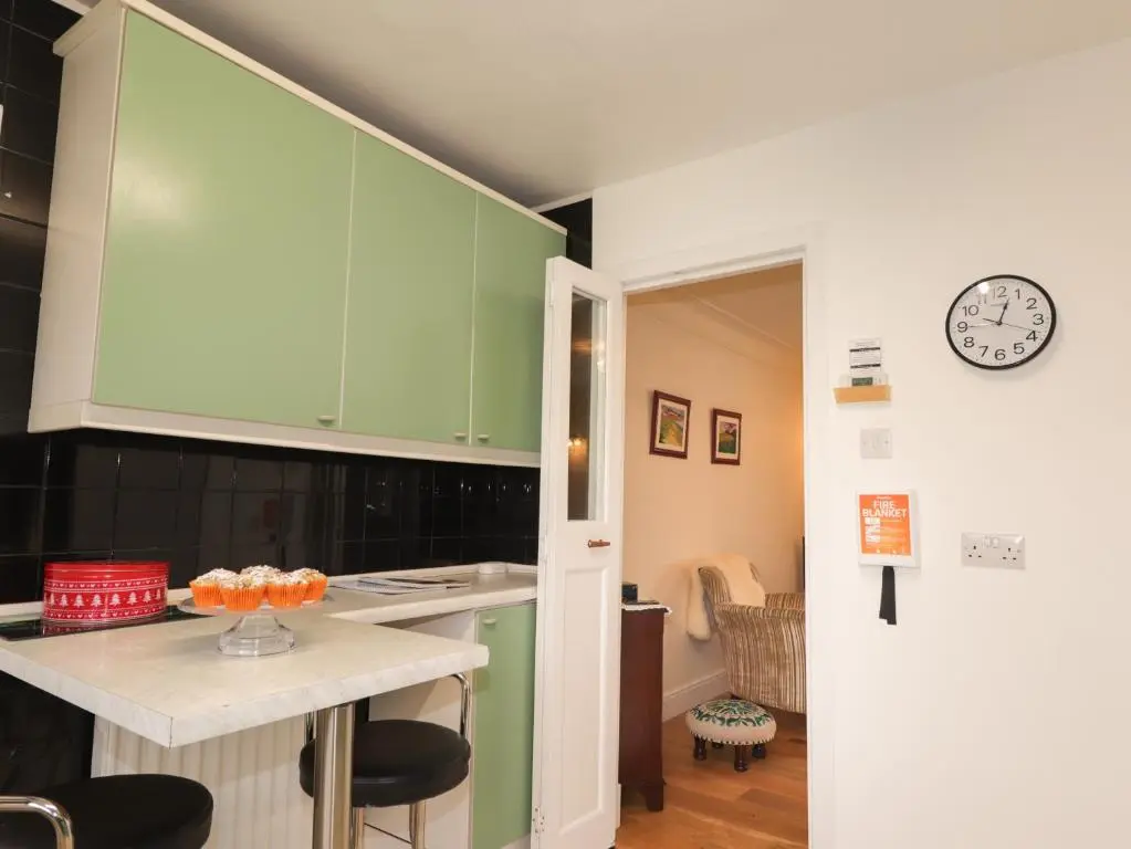 a kitchen with green cabinets and a counter top at Tommy's in Inverness