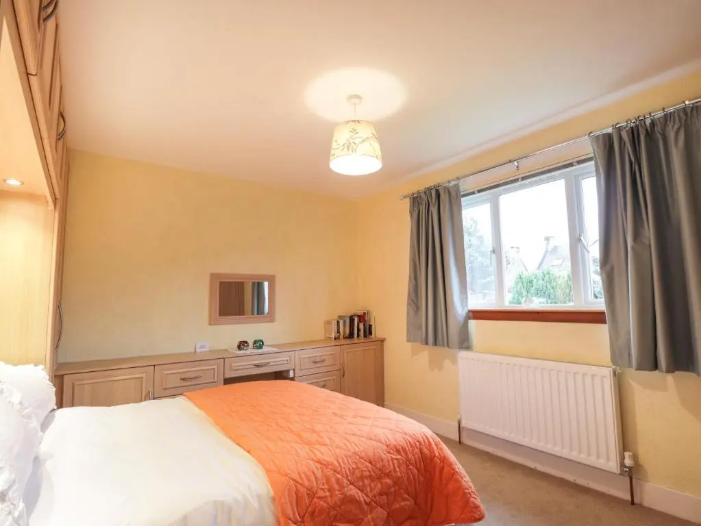 a bedroom with a bed and a window at Tommy's in Inverness