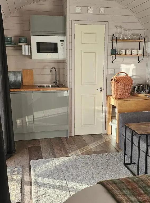 a kitchen with a sink and a microwave at Dunbeath Coastal Retreat in Dunbeath