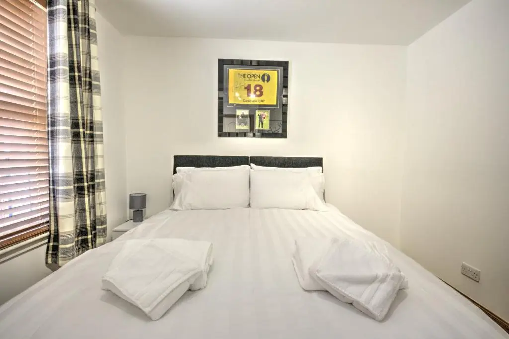 a white bed with white pillows in a bedroom at 5 Argyle Place, Dornoch in Dornoch