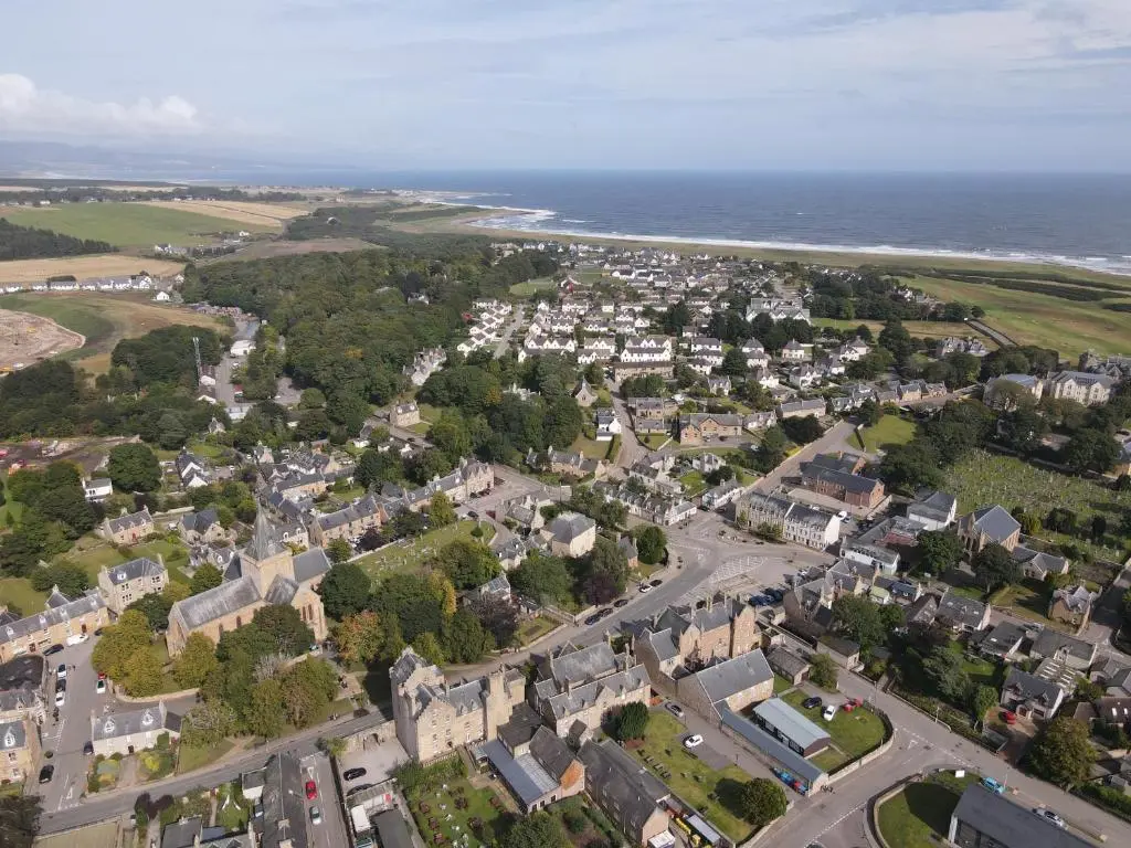 an aerial view of a town next to the ocean at 5 Argyle Place, Dornoch in Dornoch
