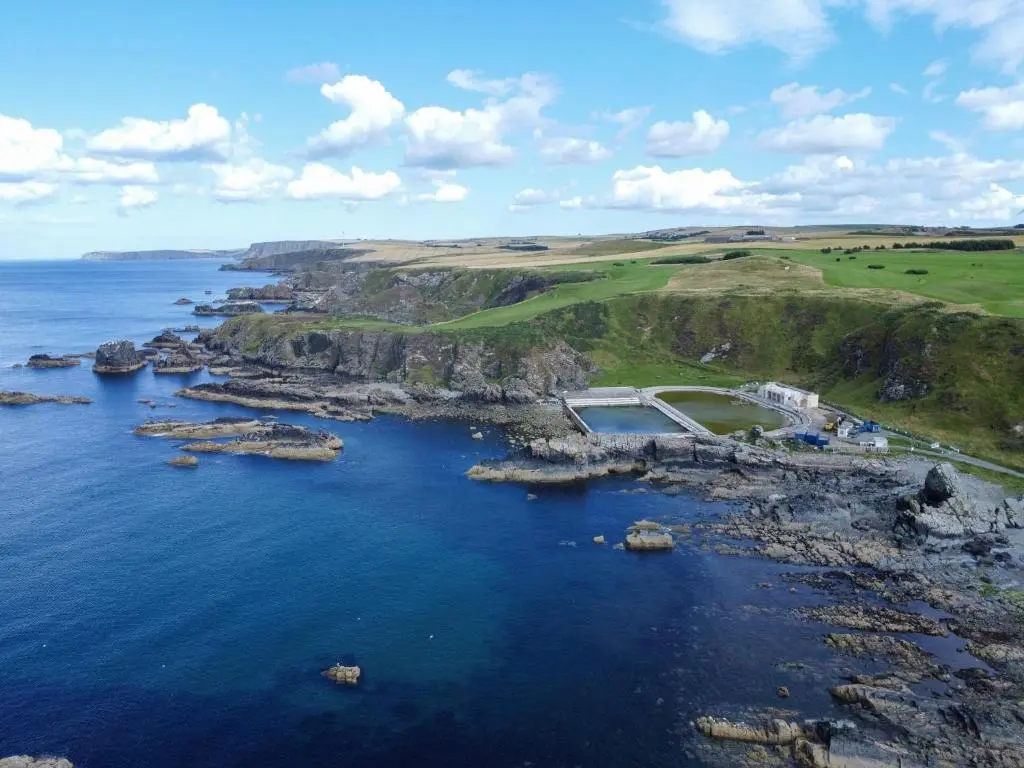 an aerial view of a rocky island in the ocean at Moray View, Macduff, Aberdeenshire. in Macduff
