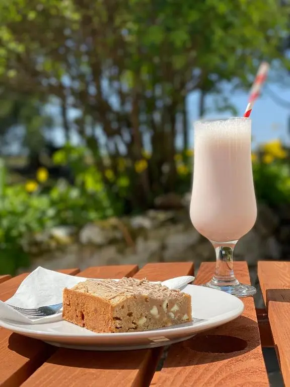 a plate with a slice of bread and a glass of milk at Forsinard Lodge in Forsinard