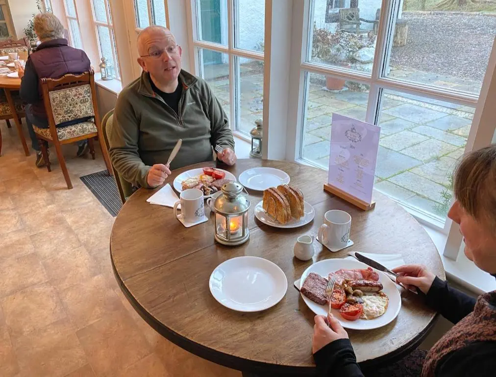 a group of people sitting at a table eating breakfast at Forsinard Lodge in Forsinard