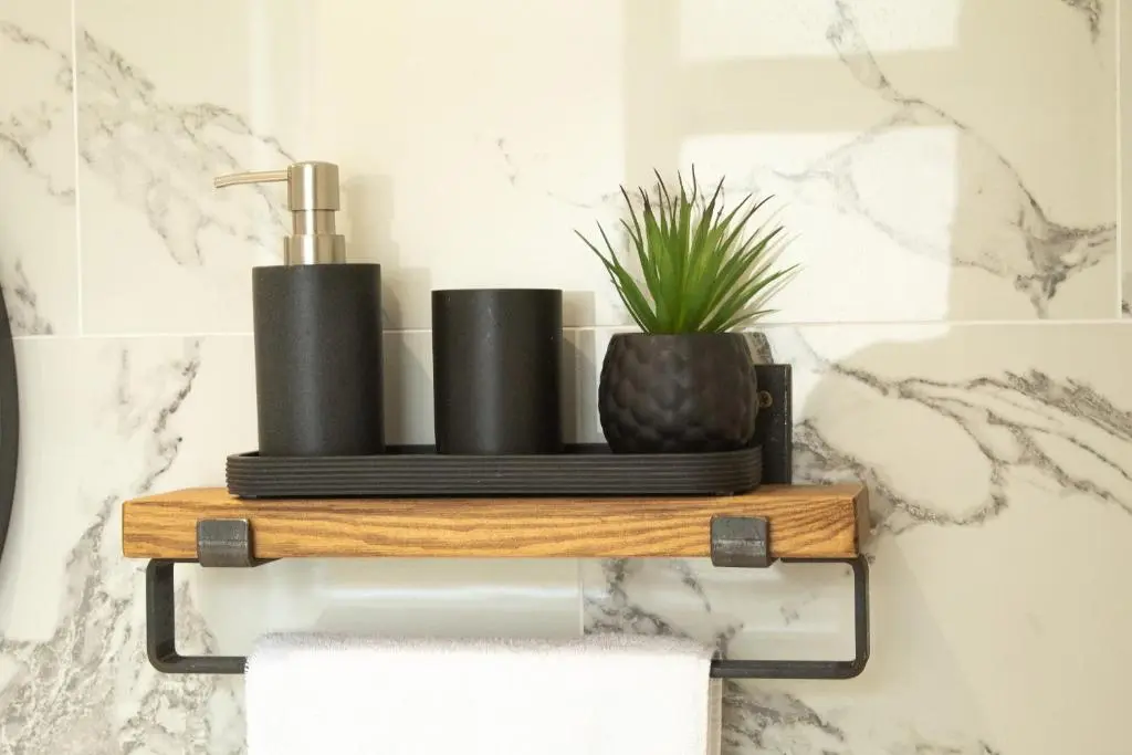 a bathroom with a wooden shelf with a plant on it at Dalnaglar in Nethy Bridge