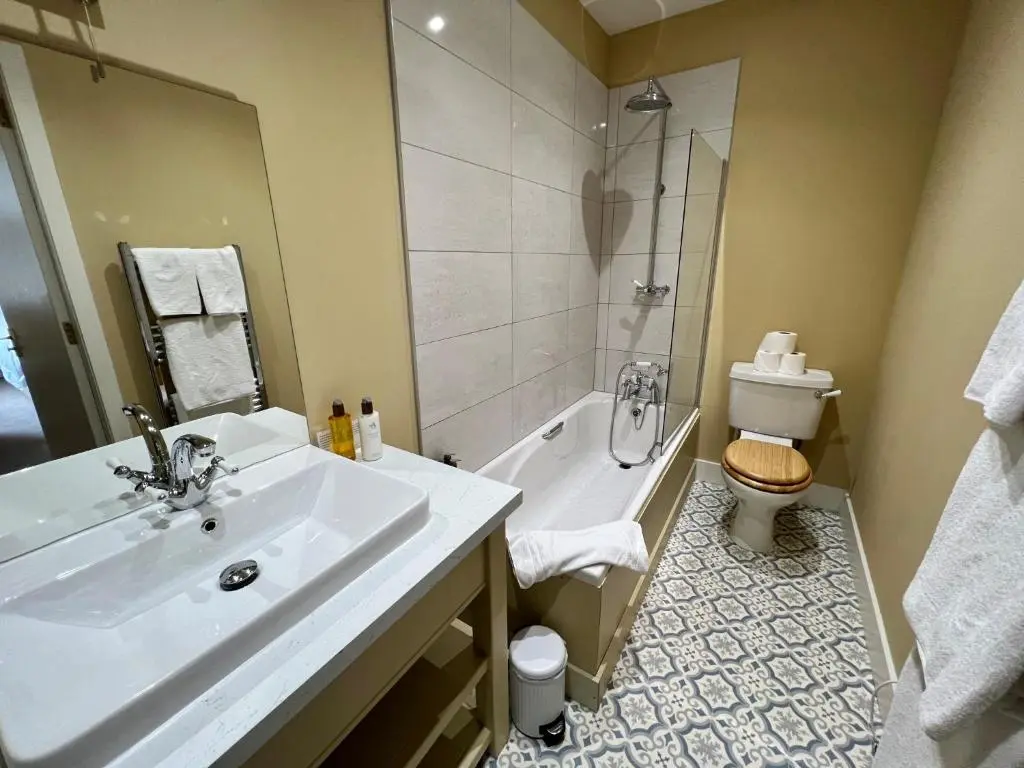 a bathroom with a sink and a shower and a toilet at St Marys Farmhouse - Traditional Country Farmhouse with Open Fire in Fochabers