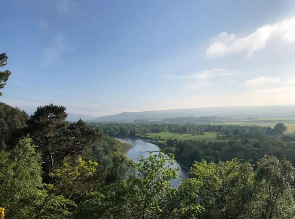 a view of a river from a hill with trees at St Marys Farmhouse - Traditional Country Farmhouse with Open Fire in Fochabers