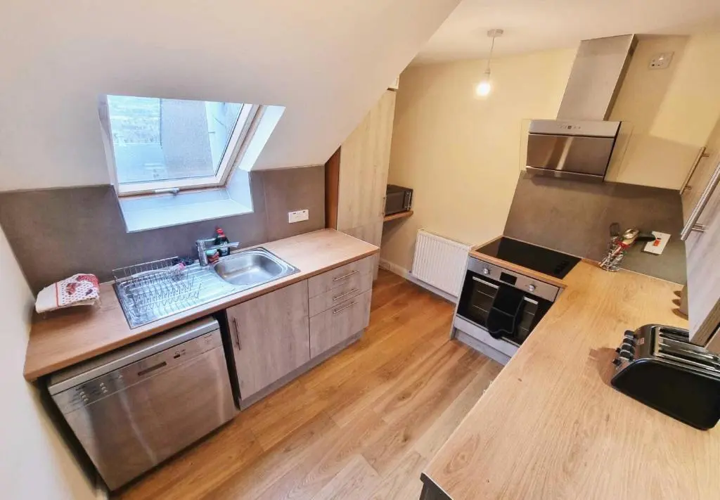 a large kitchen with a sink and a stove at Jacobite house in Inverness