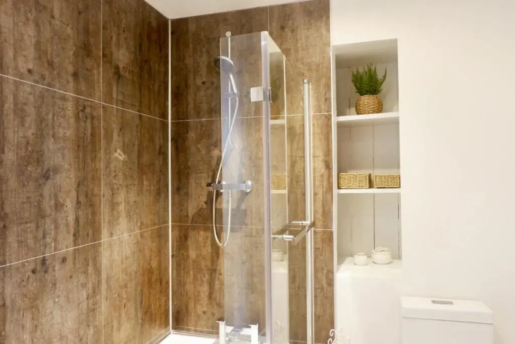a shower with a glass door in a bathroom at Jacobite house in Inverness
