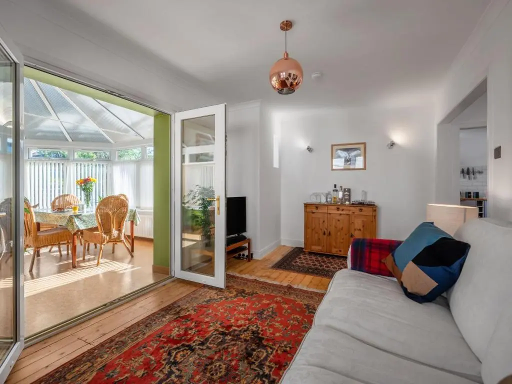a living room with a couch and a table at Holiday Home Sullivan by Interhome in Drumnadrochit