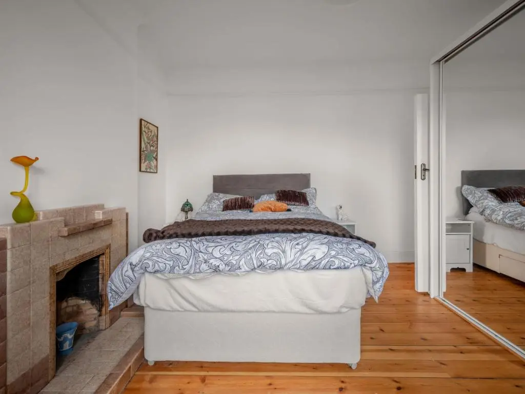 a bedroom with a bed and a fireplace at Holiday Home Sullivan by Interhome in Drumnadrochit