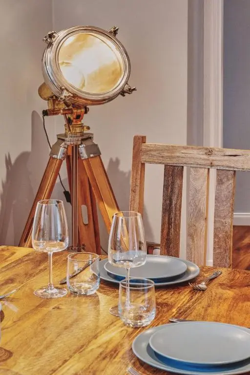 a table with glasses and a camera on a table at Loch Ness Mansion in Invermoriston