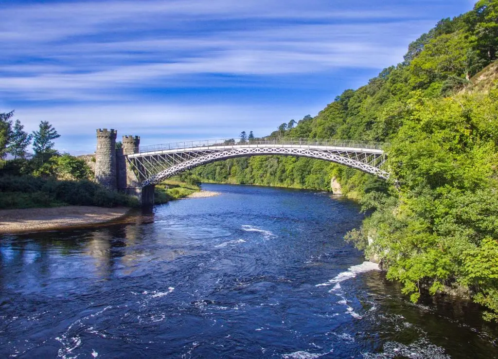 a bridge over a river next to a mountain at Taighsona Bothy, Speyside - amazing views! in Archiestown