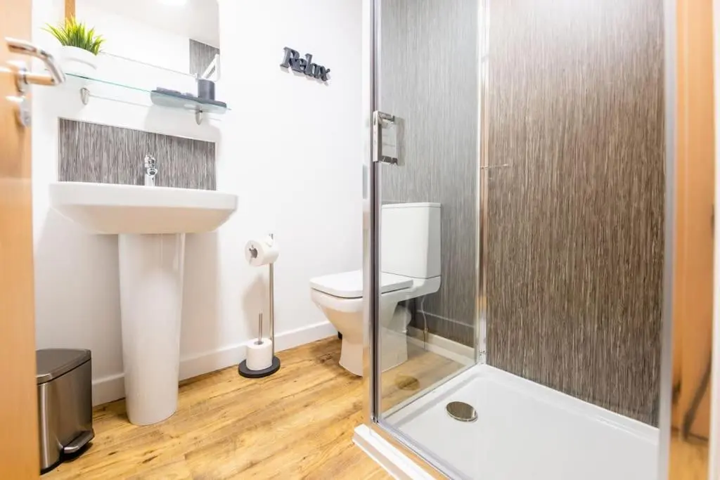 a bathroom with a toilet and a sink and a shower at Modern City Centre Apartment in Inverness in Inverness
