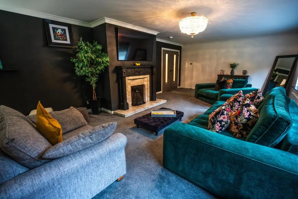 a living room with two couches and a fireplace at FAMILY FRIENDLY, HOT TUB, Fire Pit, Spacious & Modern in Fochabers