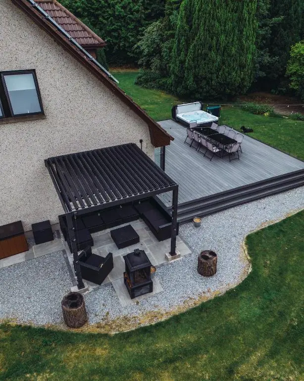 an overhead view of a patio with a grill and picnic table at FAMILY FRIENDLY, HOT TUB, Fire Pit, Spacious & Modern in Fochabers