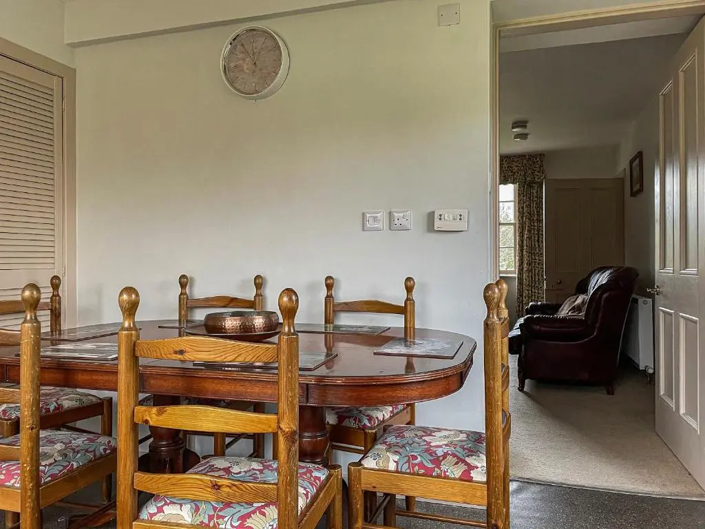 a dining room with a table and chairs at Milton Cottages in Invercassley