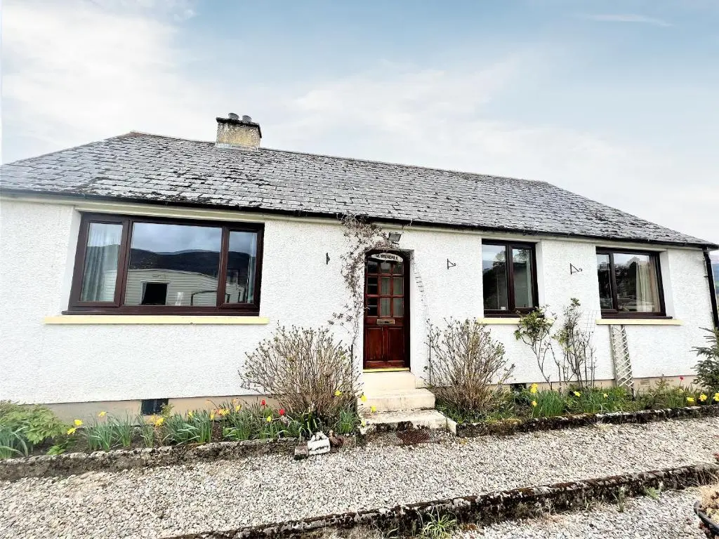 a white house with black windows and a door at Westerdales in Fort Augustus